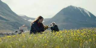 Actor Noomi Rapace interacts with disturbingly cute lamb/human hybrid toddler in the beautiful Icelandic countryside. 