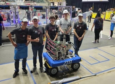A few members of the robotics team celebrate with a photo after taking on a qual. Dzialendzik (far left) and Crull(2nd from right) are included in this group.