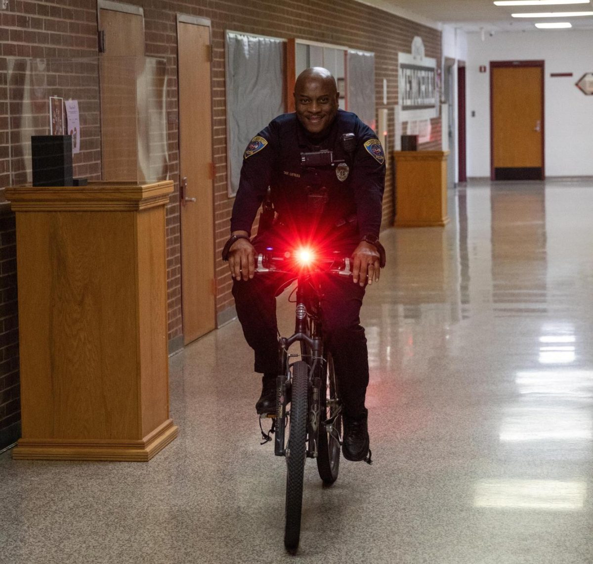Sergeant Littles riding his bicycle through the hallways.