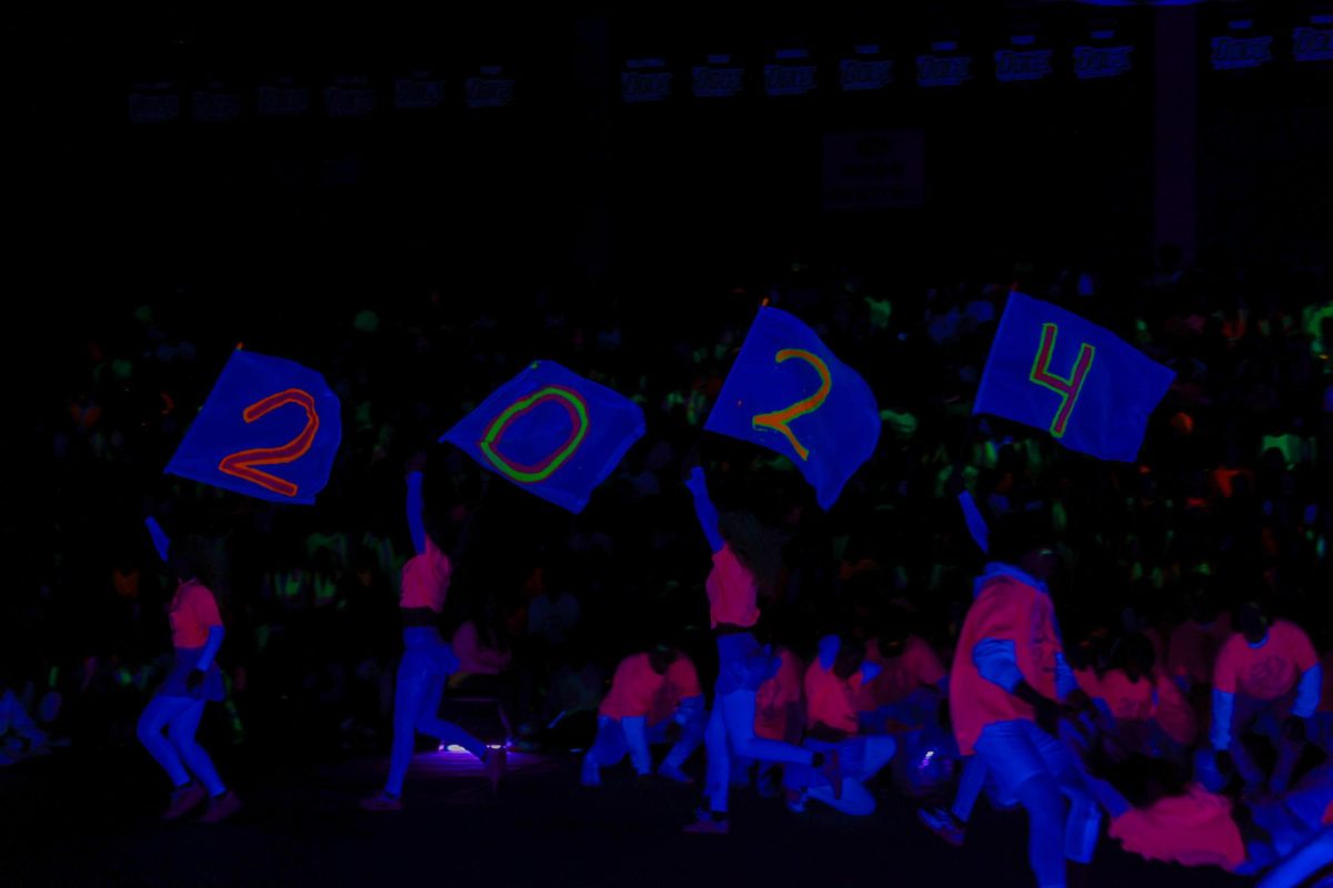 EMHS students perform intricate dances in blacklight for the student body to watch.