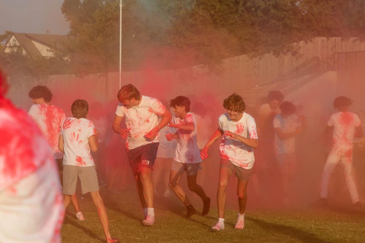 Edmond Memorial students ran through clouds of colorful smoke to celebrate the annual Color Wars. 