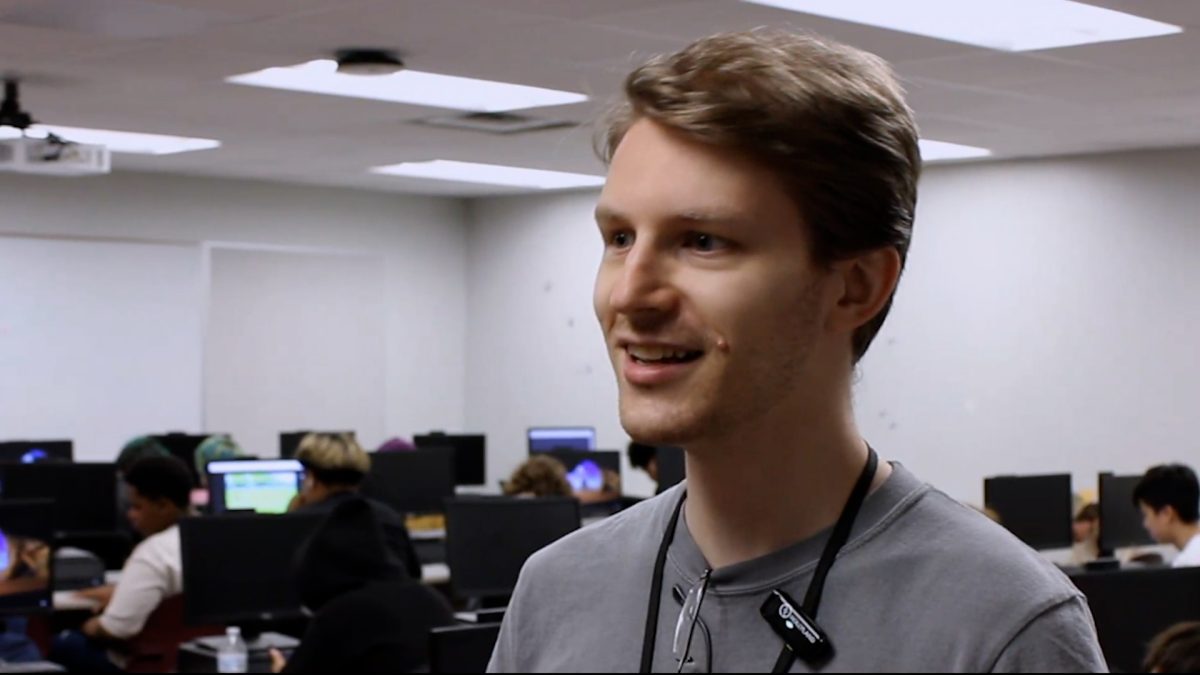 Computer applications teacher David Milligan stands in front of his students while being interviewing.