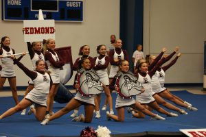 Memorial's varsity cheer team shows Edmond pride in Stroud at OSSAA Cheerleading State Regionals.