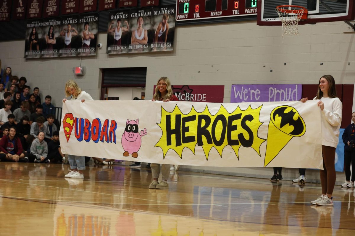 Student Council members Paige Medley, Scout Killackey and Sophia Scott announce the 2025 Swine Week theme.