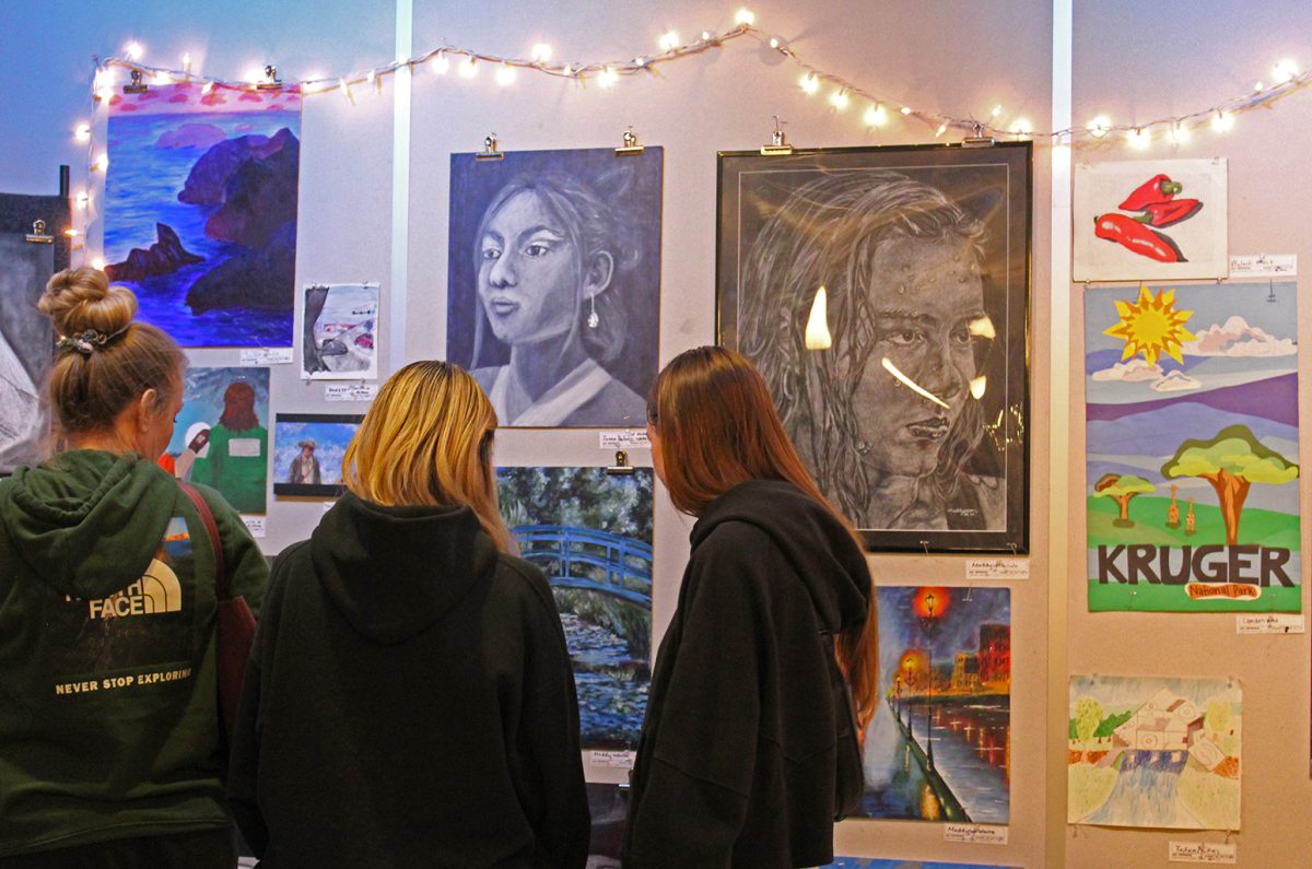 Students view art exhibits at the EMHS art show.