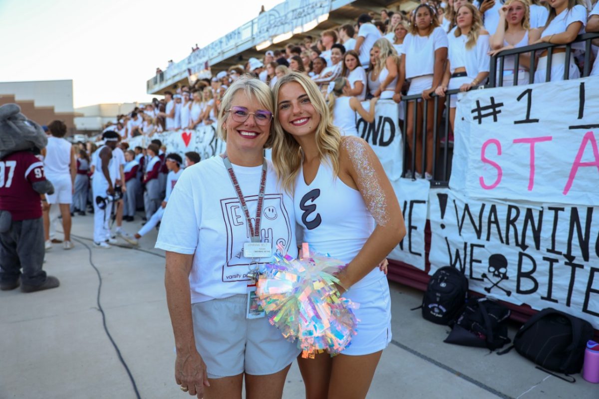 Assistant pom coach, Johanna Belt, poses with her daughter at an EMHS football game. 