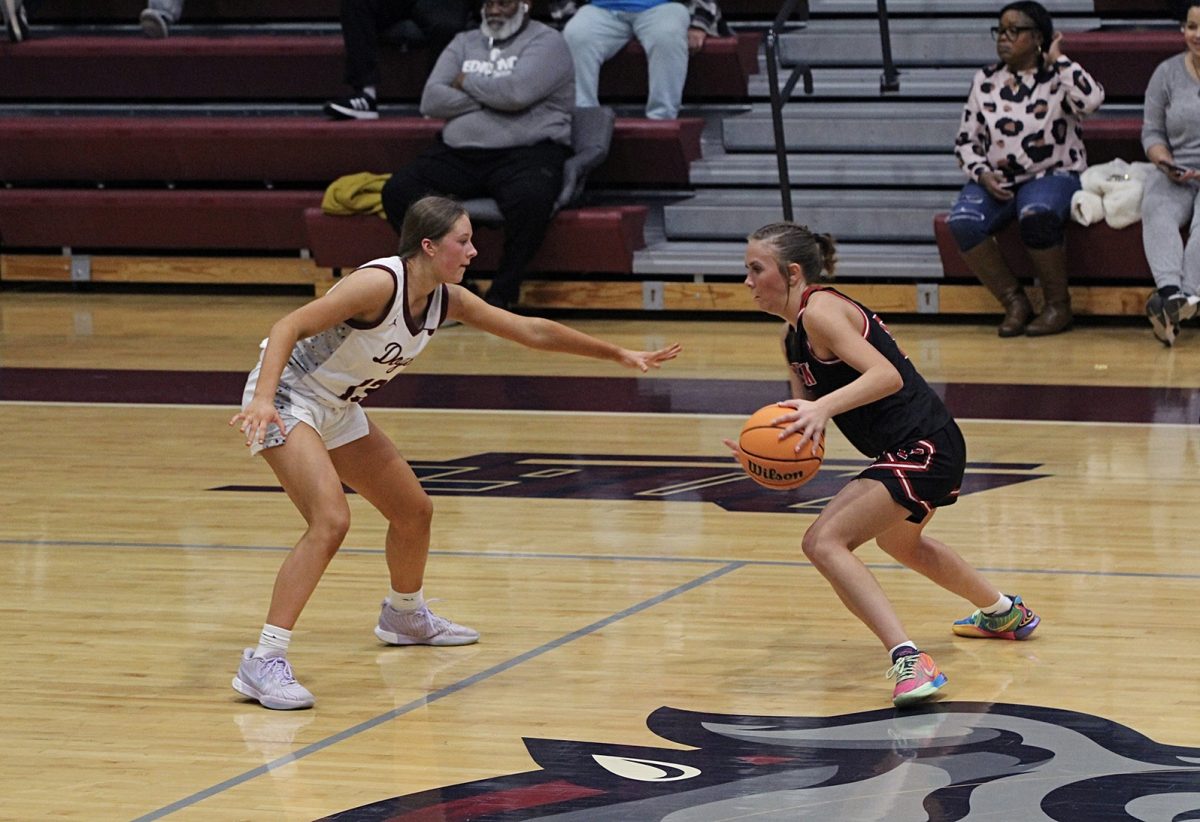 Senior Avery Hjelmstad facing Yukon and guarding their play.