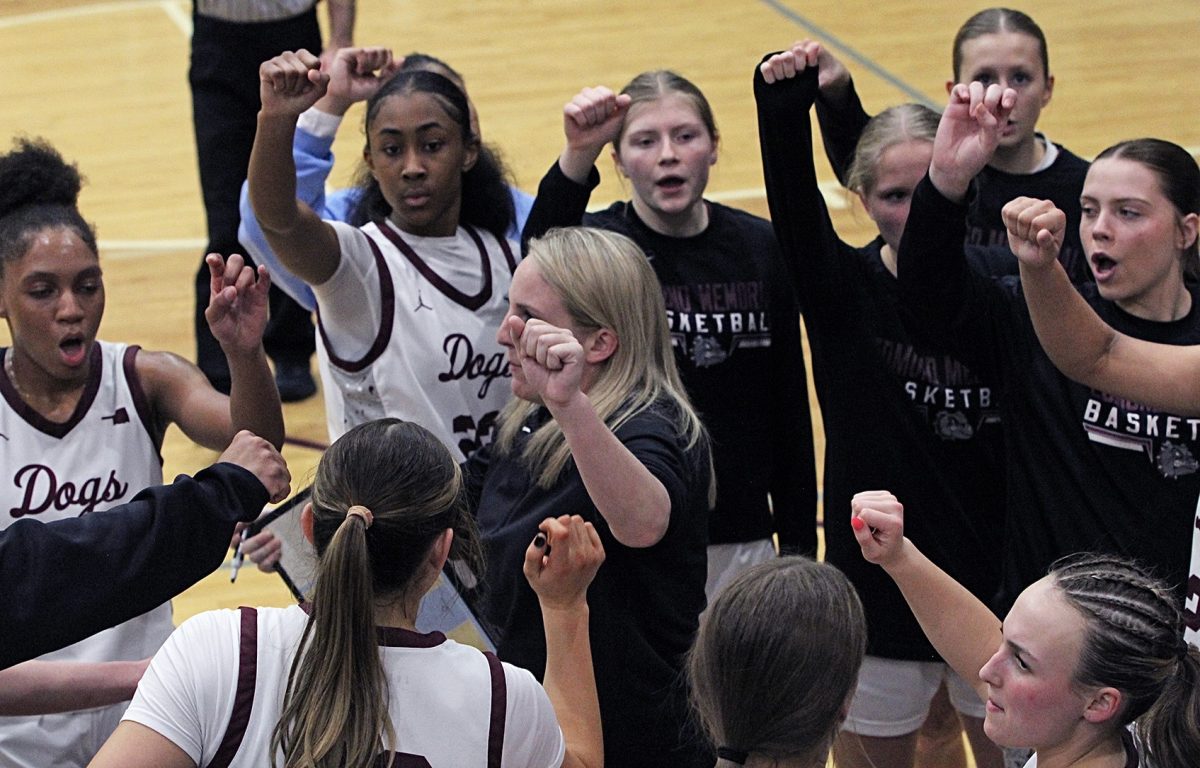 EMHS girls basketball team coming together after discussing their next game plan.