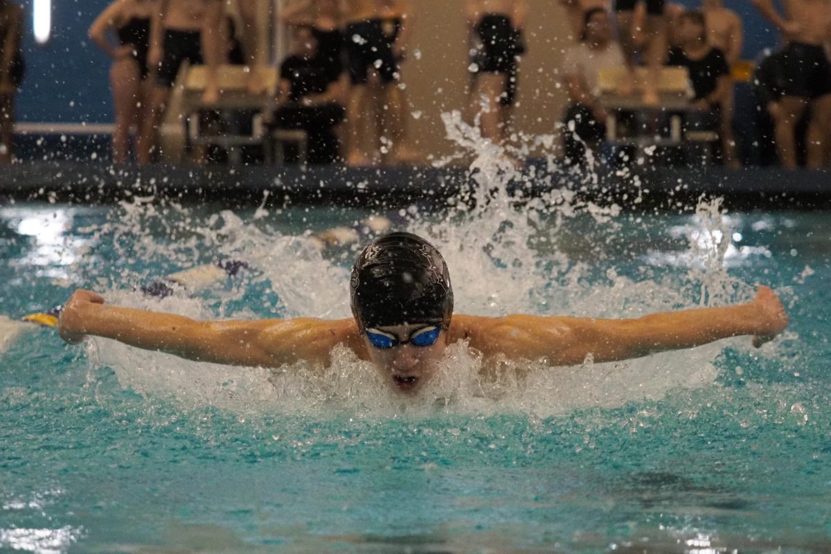 This Memorial swimmer's focus is apparent as he competes while doing the butterfly stroke.