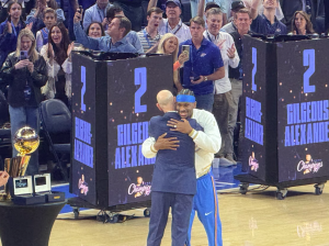 MVP Shai Gilgeous-Alexander hugging NBA Commissioner Adam Silver before receiving his championship ring.