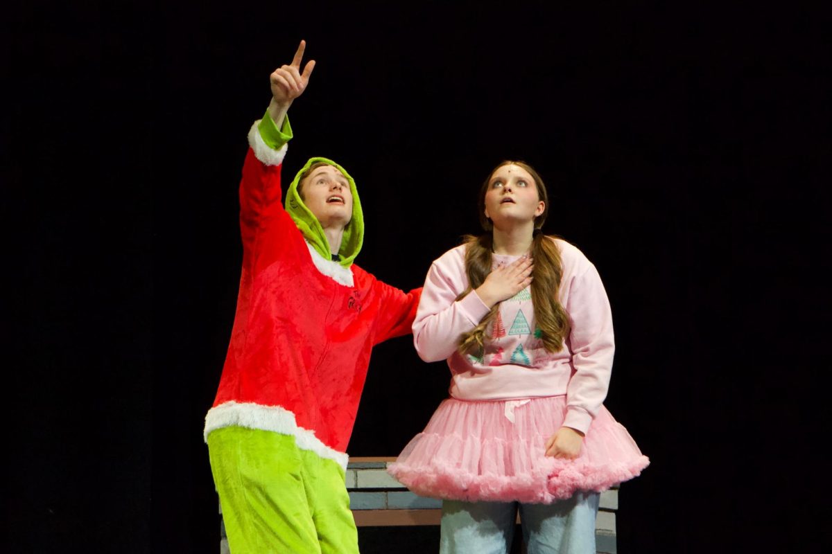 The seventh holiday struggle: decorations. The Grinch, played by Jack Deen, shows off his extravagant holiday decorations to Cindy Lou, played by Kennedy Morgan.