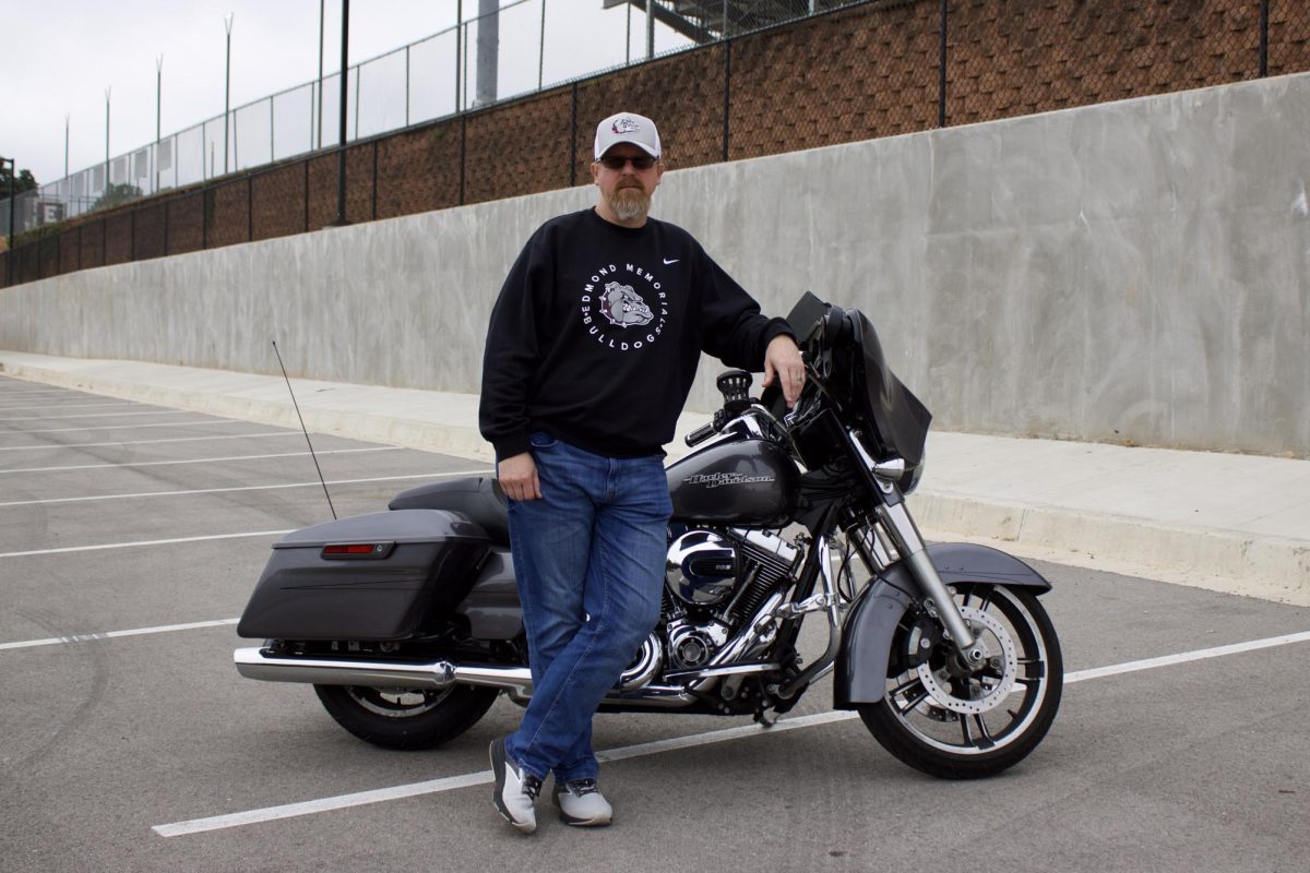 Principal Keith Pautler leans against his motorcycle, Lucille. 