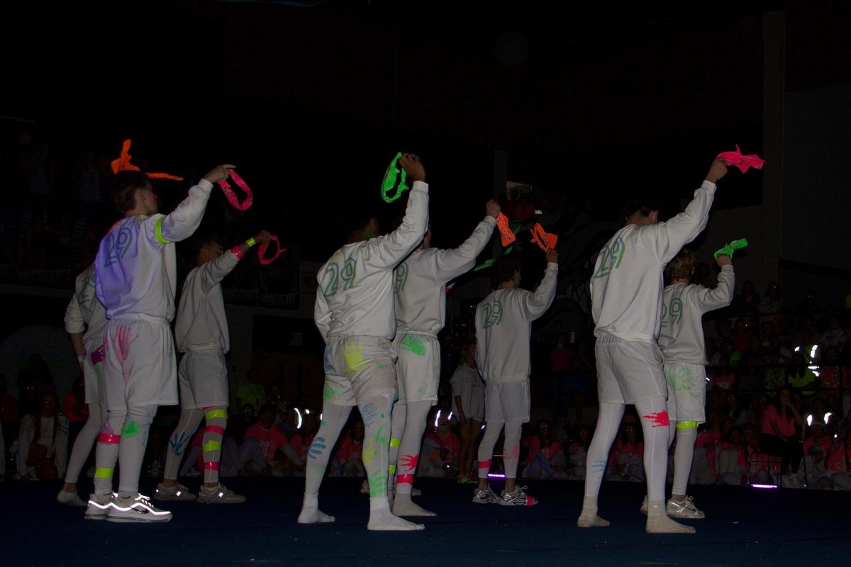 The freshmen take off their colorful headbands and wave them in the air in part of their performance. 