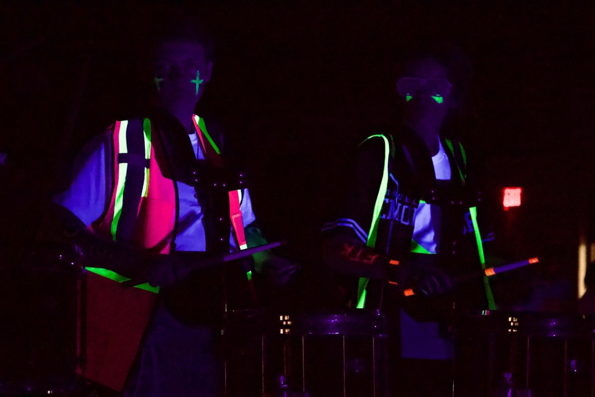 Senior Michael Austin and freshman Caleb Vickery play in the drumline's Techno performance. 