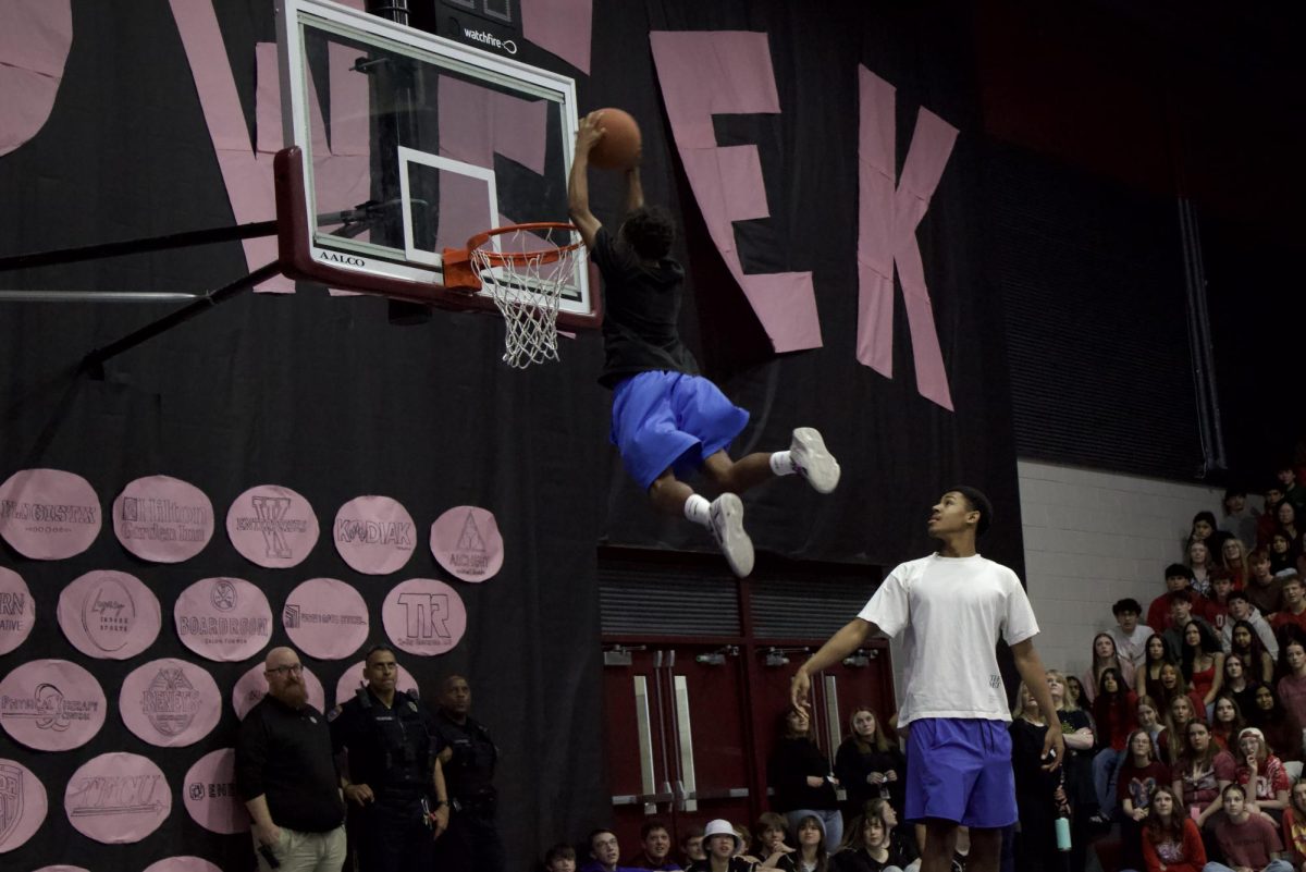 Sophomore Jaden Childs leaps to dunk the basketball, earning a point and winning the dunking competition for the sophomores.
