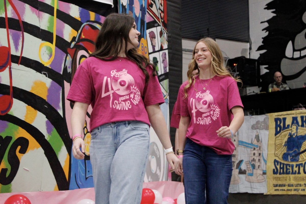 Kalle Hays and Grayson Gantz look each other and smile as they walk both walk next to the stage for raising money for Special Care.
