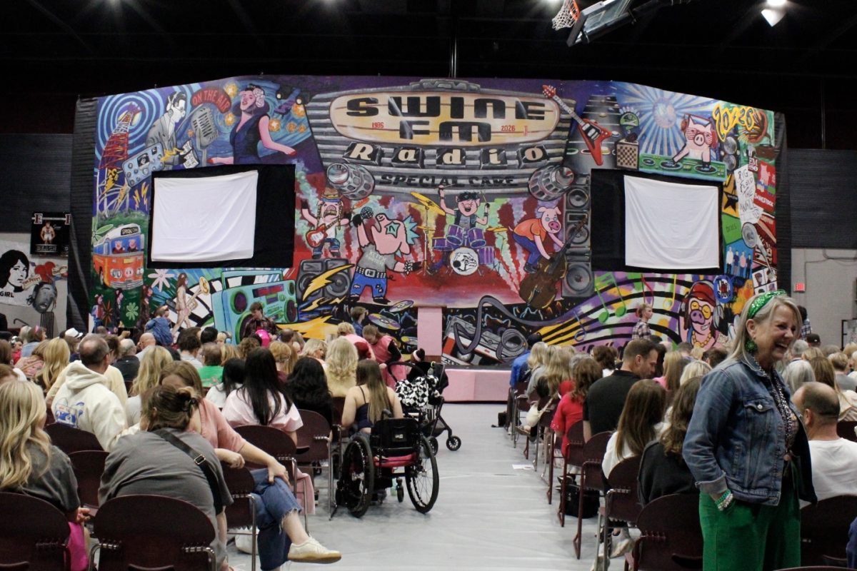 The audience faces the Piggy Vision mural as they wait for the final assembly of Memorial's 40th Swine Week to begin.