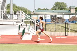 Sophomore Chase Whitaker runs as he tries to pass the baton to the other player.
