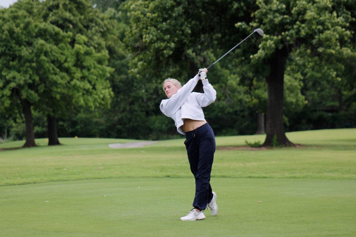 Senior Campbell Moore hits a perfect stinger off the 13th tee.
